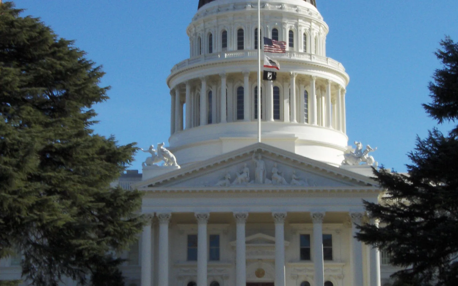The neoclassical California State Capitol building in downtown Sacramento with its distinctive dome visible against the sky